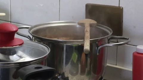 Steel pots boiling on the fire in the kitchen Stock Footage 72942761