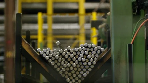 Steel Rods Falling into Place Into Triangular Bin At Manufacturing Plant Stock Footage 125498975