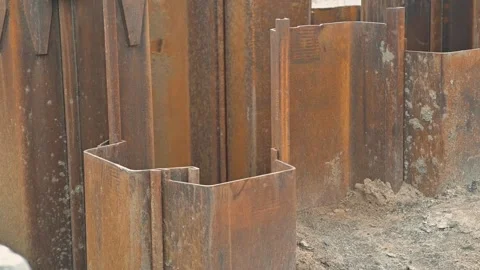Steel sheets are being placed in an excavation site to provide support during Видео 344675775