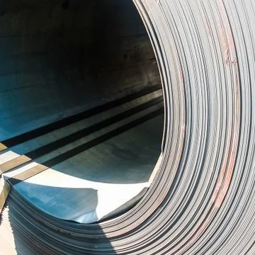Steel sheets rolled up into rolls. Export Steel. Packing of stee Stock Photos