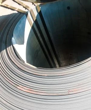 Steel sheets rolled up into rolls. Export Steel. Packing of stee Stock Photos
