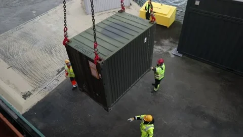Steel shipping container attached to chains being lowered to the ground  Stock Footage 233684108