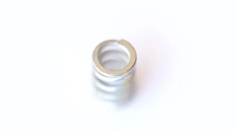 Steel spring rotates on white Video stock 35520252