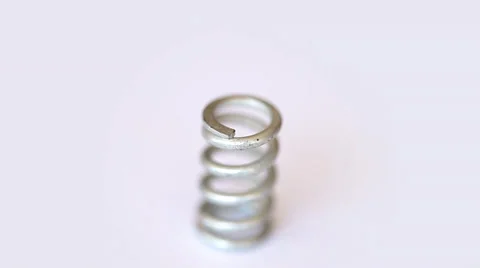 Steel spring rotates on white Vídeo Stock 35520402