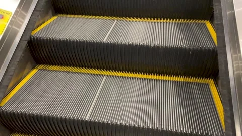 Steel steps of the escalator close-up in motion Stock Footage 240490738