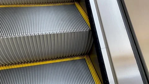 Steel steps of the escalator close-up in motion Stock Footage 242789129