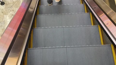 Steel steps of the escalator close-up in motion Stock Footage 243914520