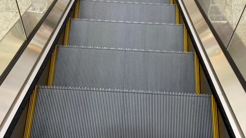 Steel steps of the escalator close-up in motion Stock Footage 245486860