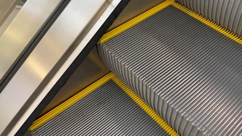 Steel steps of the escalator close-up in motion Stock Footage 246976977