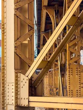 Steel structures support train tracks in an urban area during daylight hour.. Stock Photos