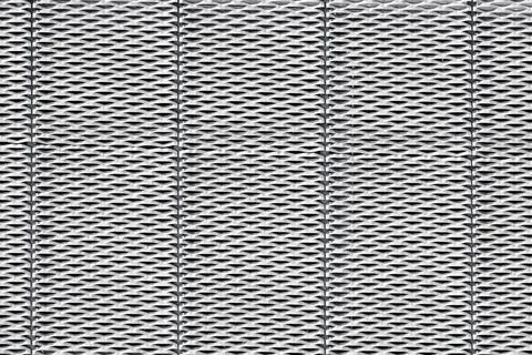 Steel surface with a repeated, geometric pattern of perforations resemblin... Foto stock
