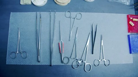 Steel surgical instruments arranged on the table Stock Footage 297260964