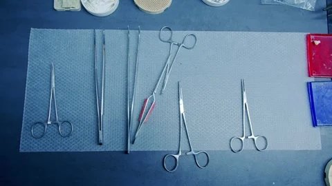Steel surgical instruments arranged on the table Stock Footage 297261095