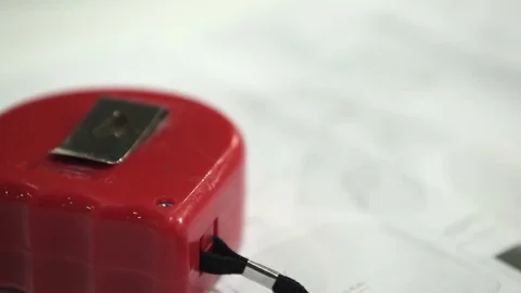 Steel tape measure extreme close up shooting with blue print Stock Footage 128929045