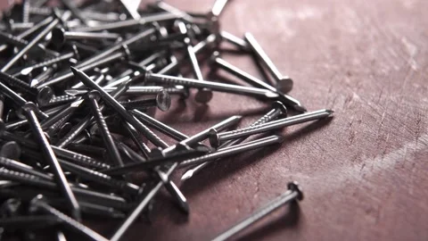 Steel thin sharp nails on a wooden board. Macro Stock Footage 166026447