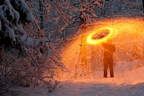 Steel wool burning in a snowy forest Stock Photos