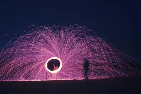 Steel wool firework with shadow of a man An image of a steel wool firework... Stock Photos