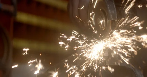 Steel worker with angle grinder making hot glowing sparks Stock Footage 120618532