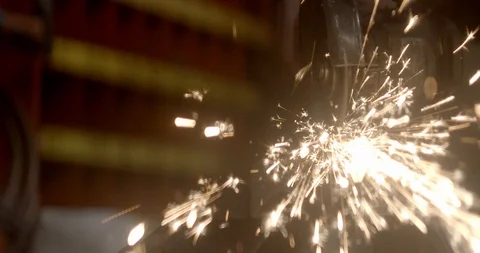 Steel worker with angle grinder making hot glowing sparks Stock Footage 120618610