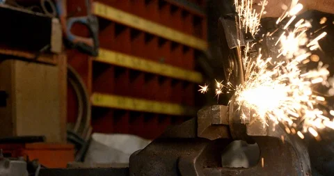Steel worker with angle grinder making hot glowing sparks Stock Footage 120618642
