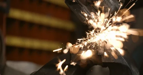 Steel worker with angle grinder making hot glowing sparks Stock Footage 120618682
