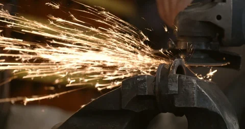 Steel worker with angle grinder making hot glowing sparks Stock Footage 120618700