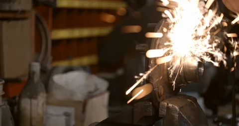 Steel worker with angle grinder making hot glowing sparks Stock Footage 120645534
