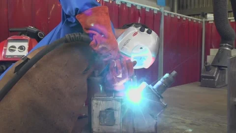 Steel worker welding iron pipe in metal workshop Stock Footage 237316183
