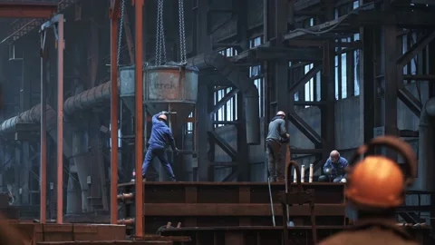 Steel workshop workers clean mold and container from sludge in foundry, heavy Stock Footage 153473228