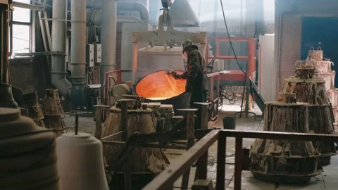 Steelmaker in the foundry. Hard work in a foundry. Metal smelting furnace in Stock Footage 155378251