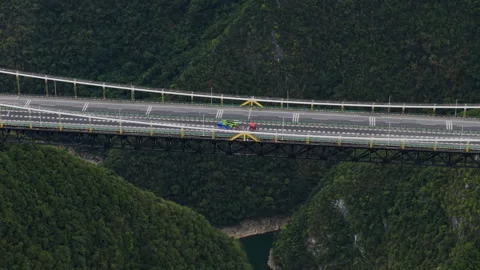 Steep Aerial Forward Tilt Down Suspension Bridge Deck 4K HLG Stock Footage 345620493