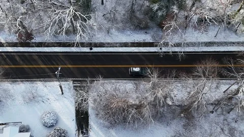 Steep Angle Side Scroll of Dark Car passing Through shot window Snow Stock Footage 296074869