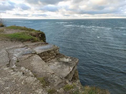 Steep banks, cliffs over the blue sea. The rocks are located on the right. La Stock Photos