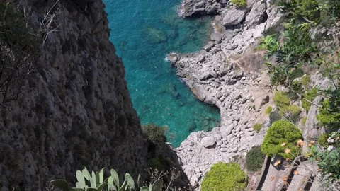 Steep Capri Cliff Opening to Clear Turquoise Cove Stock Footage 345621691