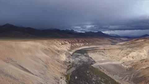 Steep Cliff and Riverbed with Snowy Mountains Stock Footage 313379819