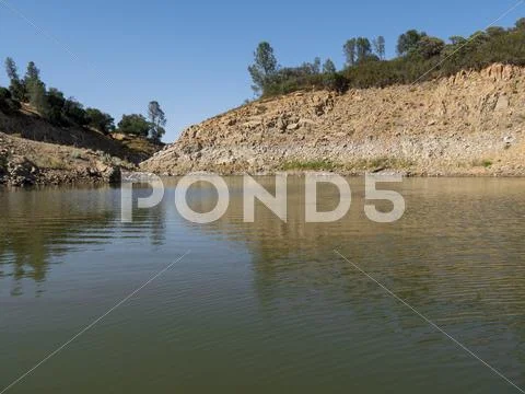 Steep Cliff Edge of Lake Shore Stock Photos