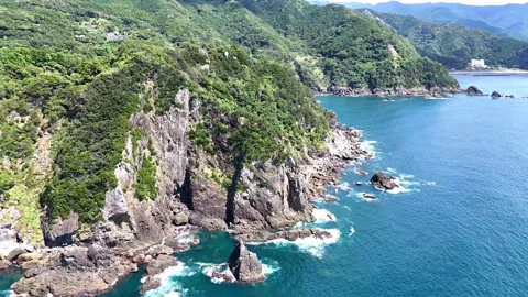Steep Cliff | Rock Face | Blue Ocean | Waves | Geopark Stock Footage 328983061