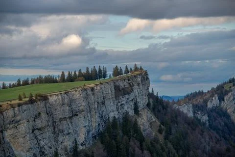 A steep cliff under cloudy sky 写真素材