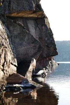 Steep cliffs and reflection in water Foto stock