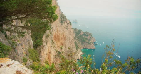 Steep cliffs and turquoise sea on a misty Mediterranean coastline in Capri Italy Stock Footage 311573685