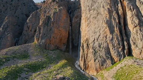 Steep cliffs and a waterfall cascading between them. Stock-Footage 332572708