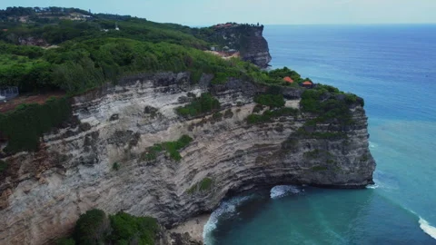 Steep Coastal Cliffs and Breaking Waves along Lush Bali Headland, Indonesia Stock Footage 342639905
