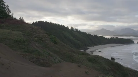 Steep coastline along Pacific Ocean on a cloudy day Stock Footage 332255129