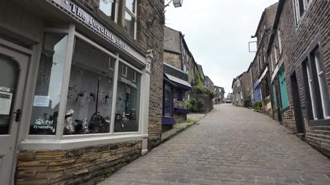 Steep Cobbled Main Street Lined with Historic Stone Shops 스톡 동영상 346523256