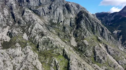 Steep dolomite cliffs and rockfalls overgrown with trees near Kotor, Montenegro Stock Footage 153693751