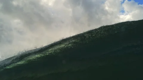 Steep Green Ocean Wave Rising Beneath Muted Clouds Near Water Level Stock Footage 344032243