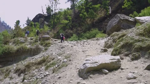 A steep hiking trail &amp; trekkers climbing, surrounded by boulders &amp; forest nearby Video stock 280267553
