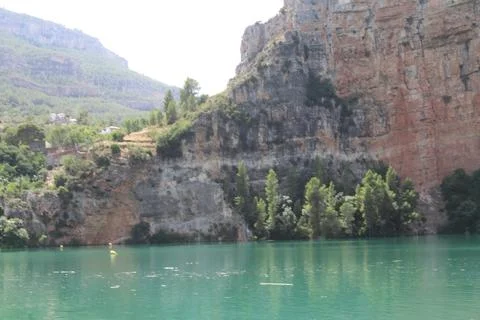 Steep Limestone Cliffs and Turquoise Water in Cortes de Pallas 写真素材