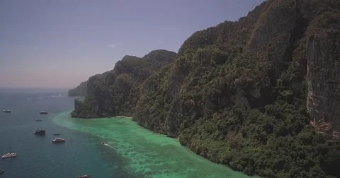 Steep Limestone Cliffs on Phi Phi Islands, Thailand, Aerial Approach Shot Video stock 75695291