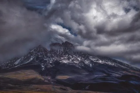 Steep mountain in dark clouds Stock Photos